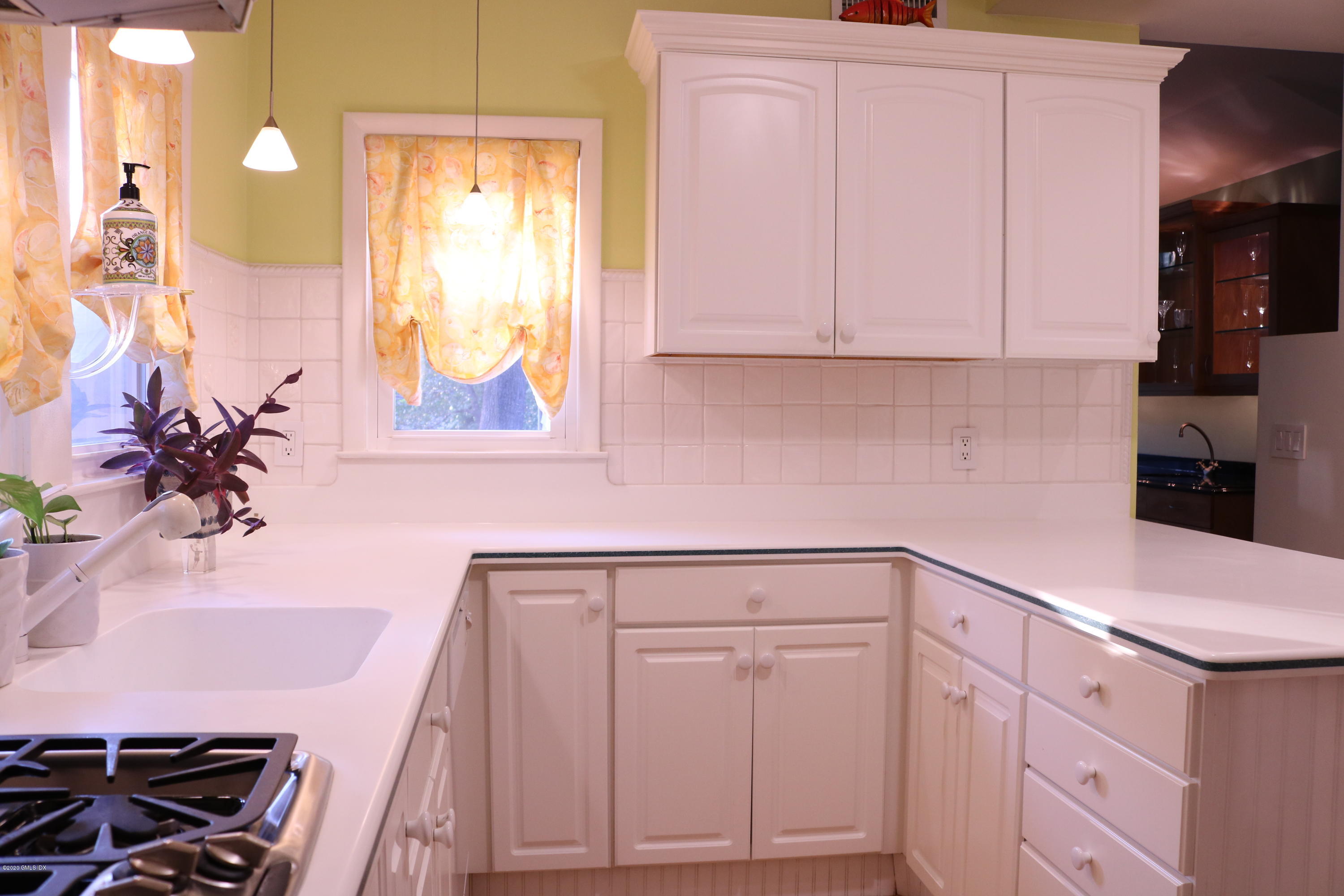 57 Shore Road Old Greenwich, CT 06870 - Photo 17 of 30 a kitchen with white cabinets and sink