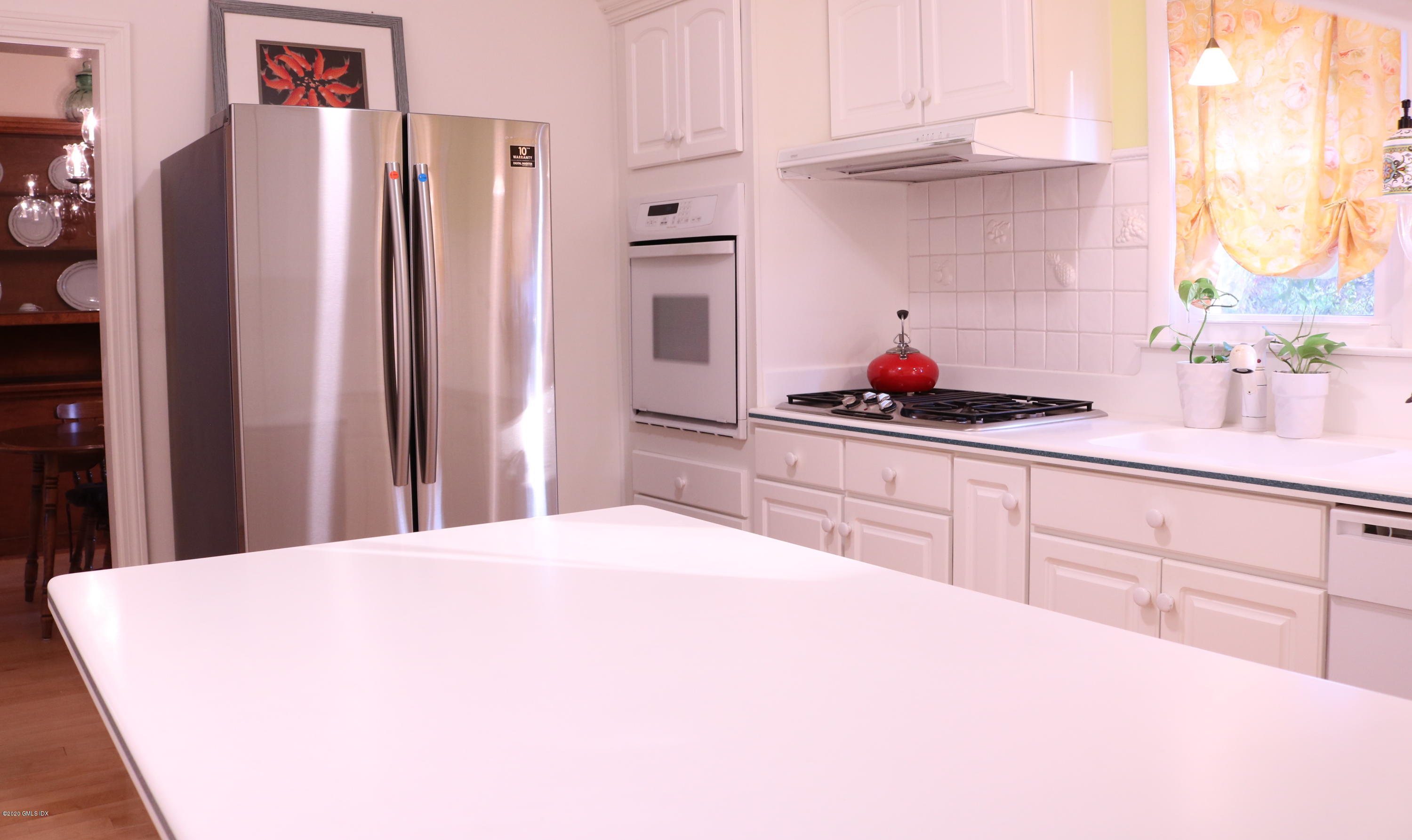 57 Shore Road Old Greenwich, CT 06870 - Photo 18 of 30 a kitchen with stainless steel appliances a refrigerator sink and cabinets