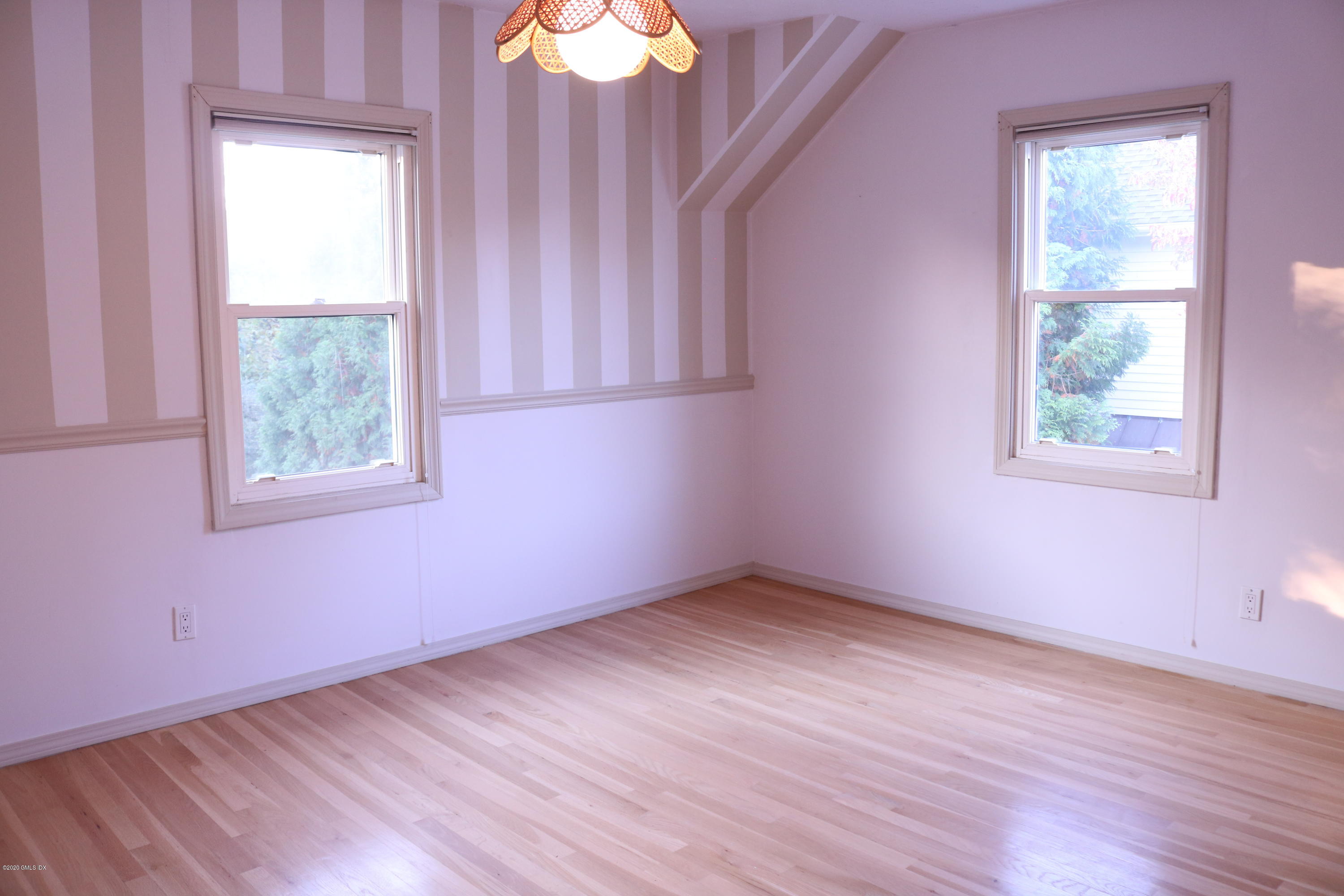 57 Shore Road Old Greenwich, CT 06870 - Photo 19 of 30 an empty room with wooden floor and windows