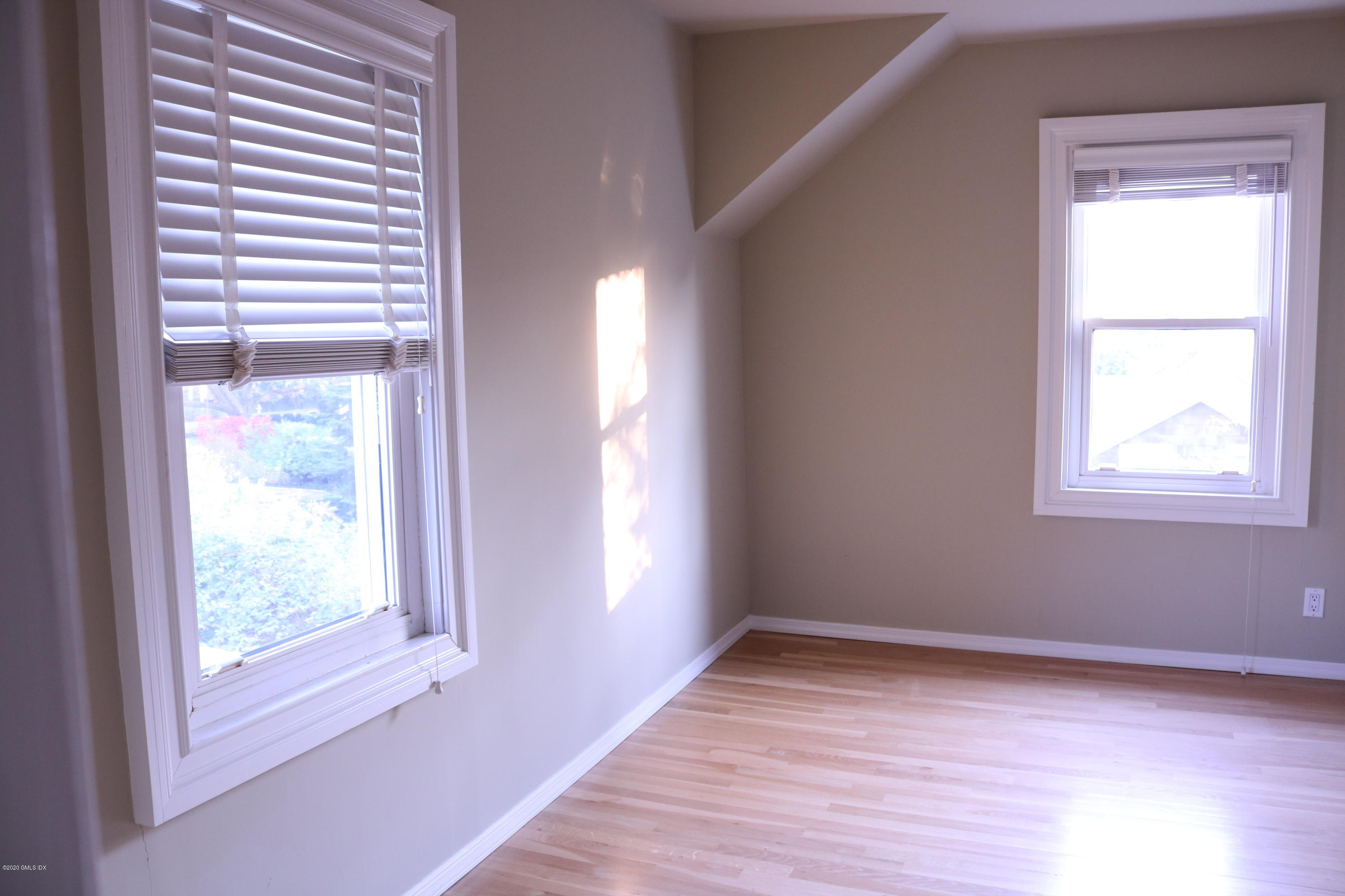 57 Shore Road Old Greenwich, CT 06870 - Photo 20 of 30 a view of an empty room with wooden floor and a window