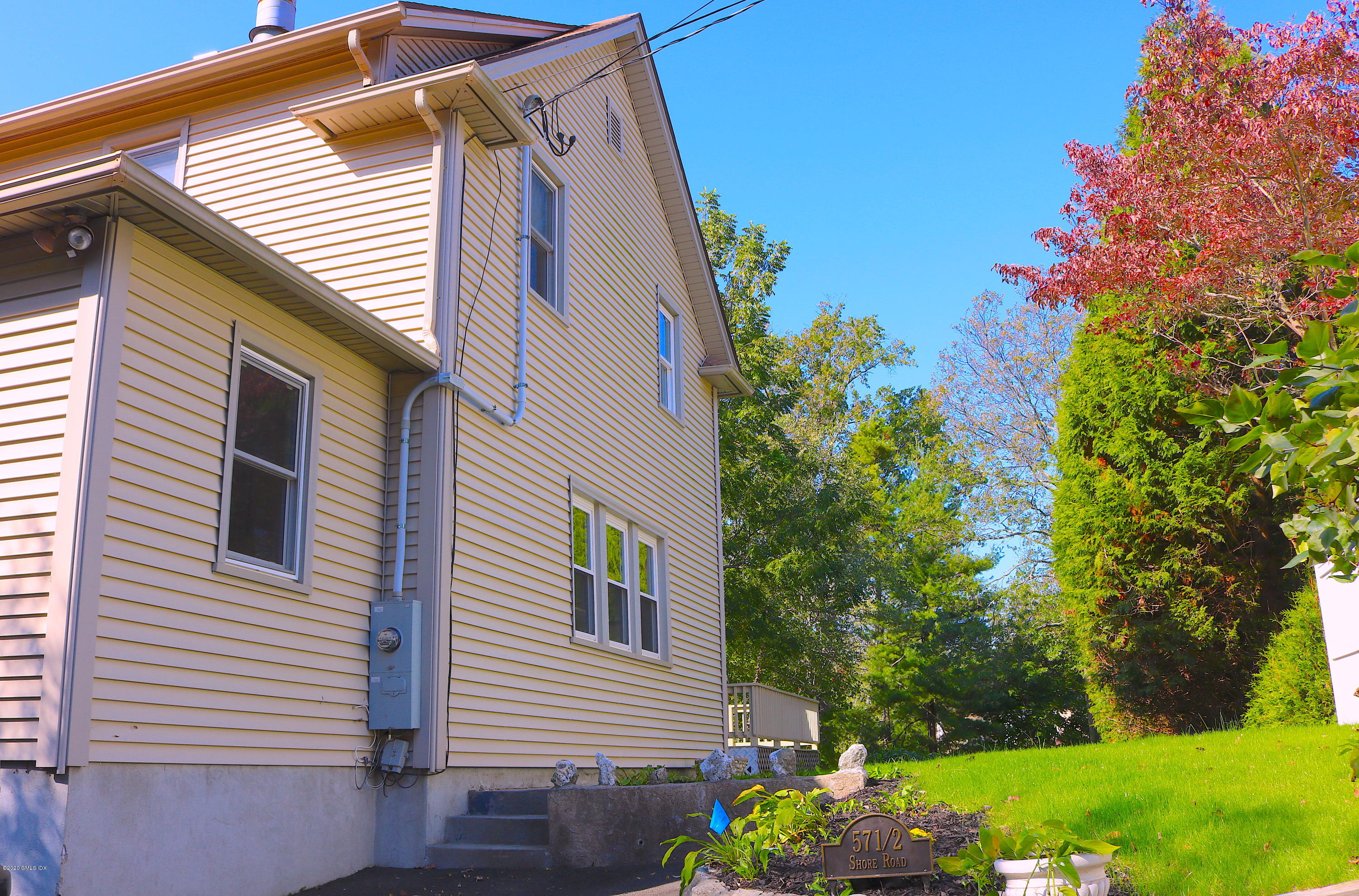 57 Shore Road Old Greenwich, CT 06870 - Photo 2 of 30 a front view of a house with a yard