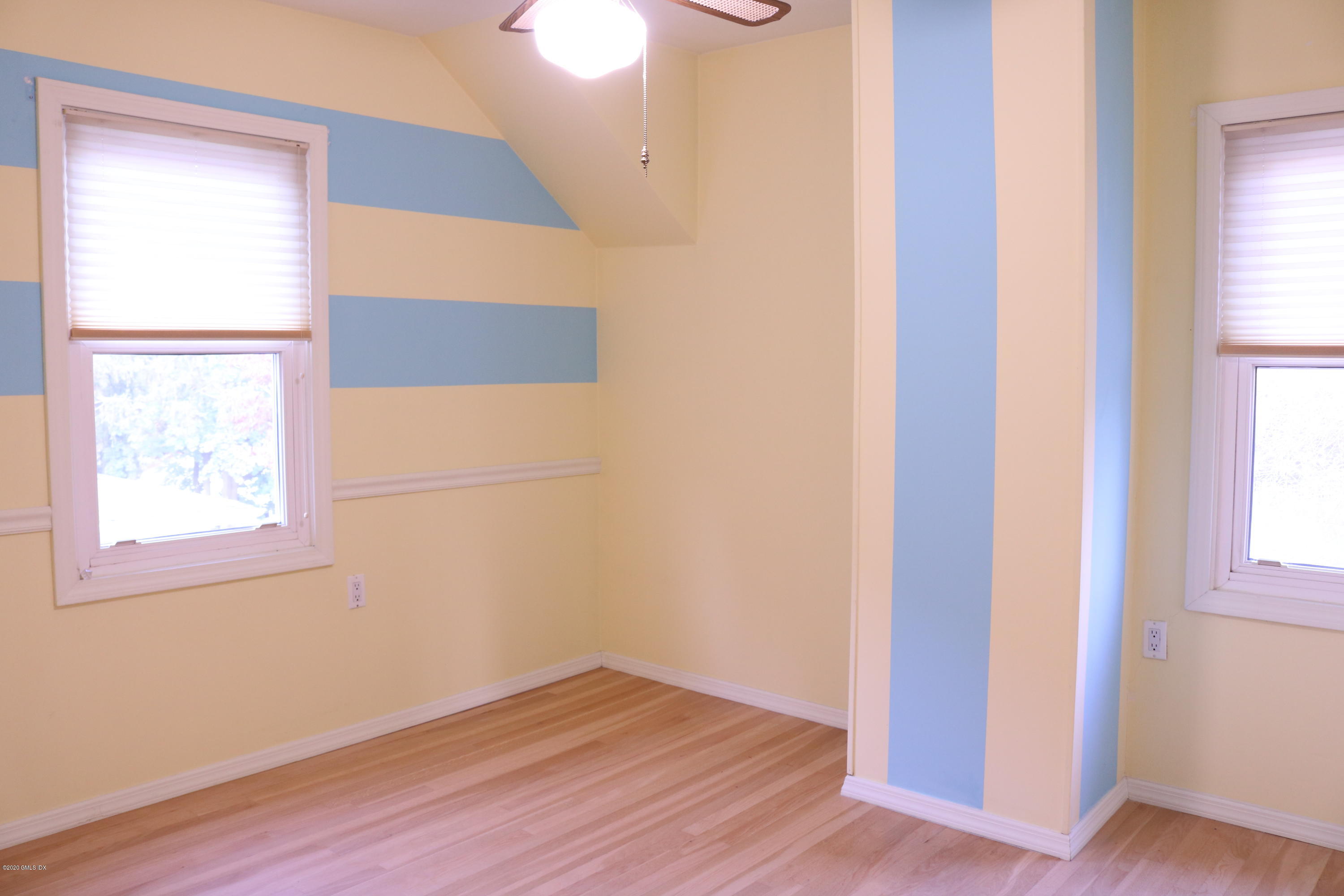 57 Shore Road Old Greenwich, CT 06870 - Photo 21 of 30 a view of an empty room with wooden floor and a window