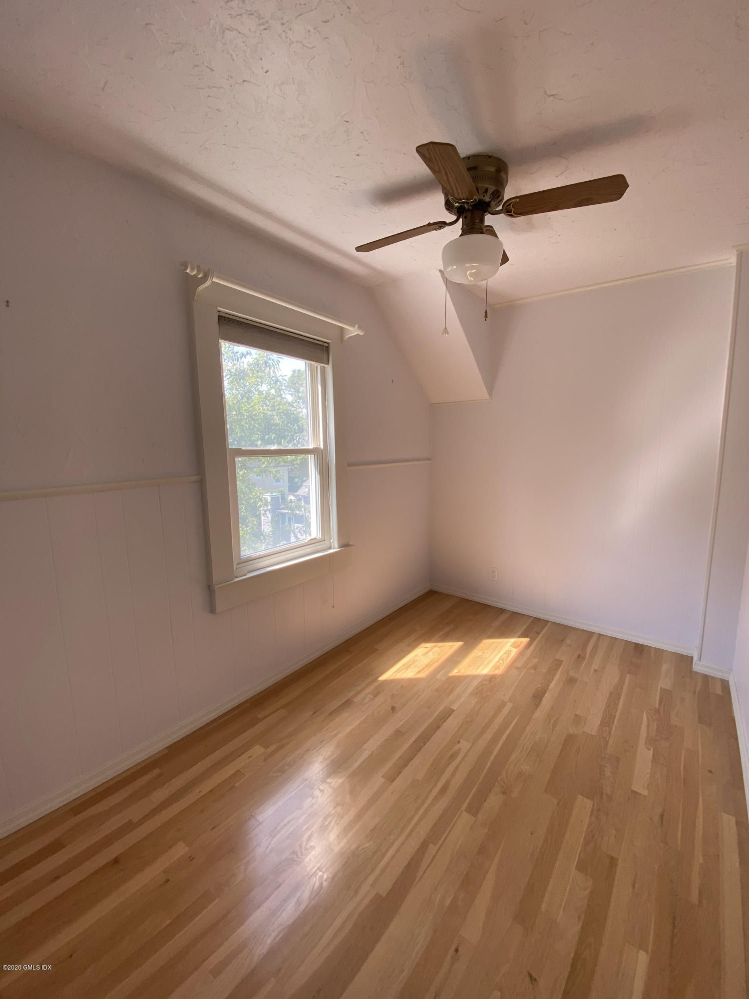 57 Shore Road Old Greenwich, CT 06870 - Photo 22 of 30 a view of empty room with wooden floor and fan