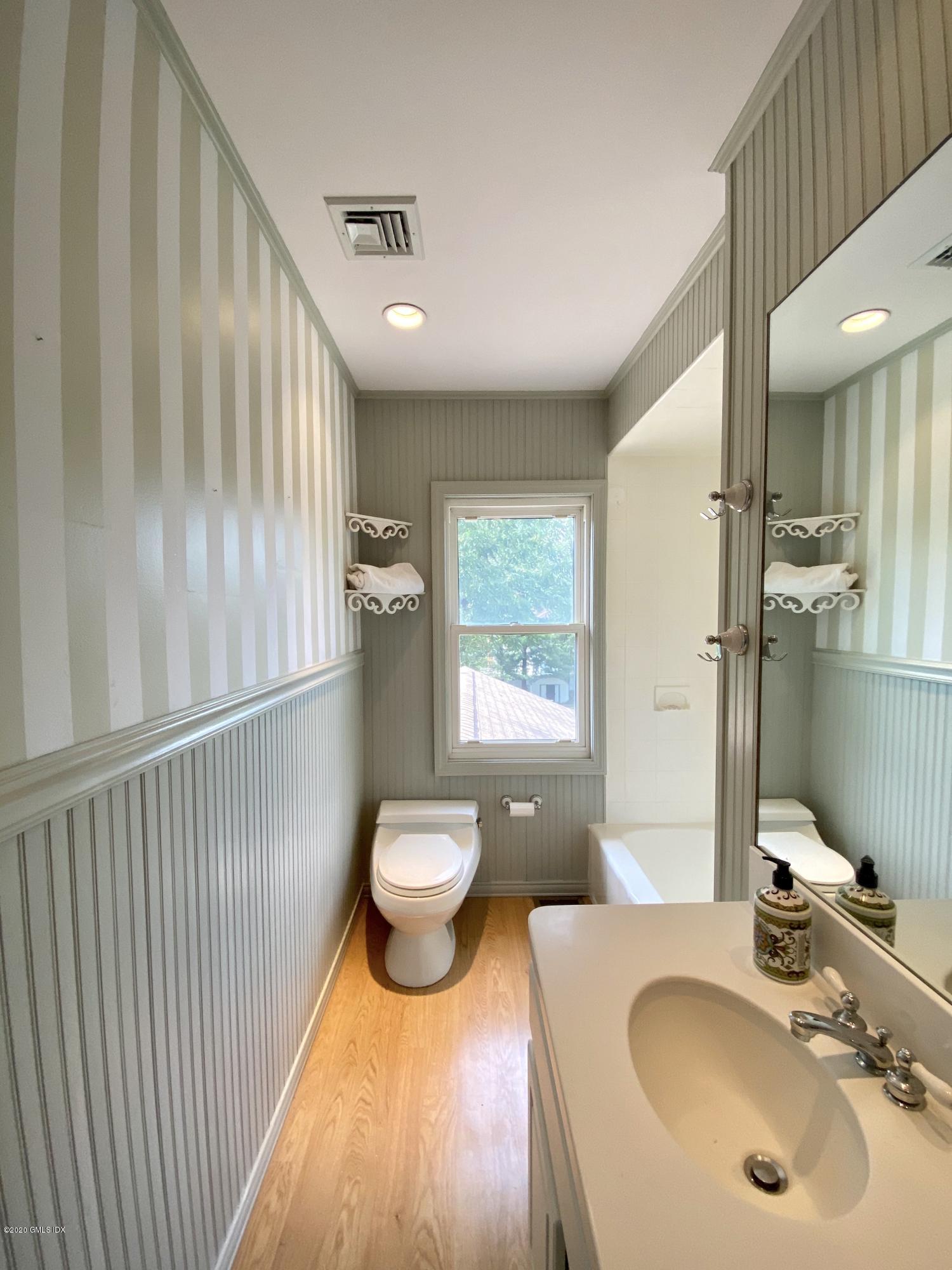 57 Shore Road Old Greenwich, CT 06870 - Photo 23 of 30 a bathroom with a sink and a mirror