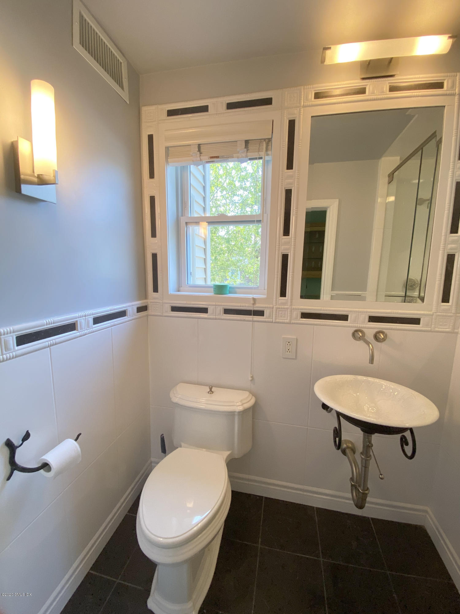 57 Shore Road Old Greenwich, CT 06870 - Photo 24 of 30 a bathroom with a toilet a sink and mirror