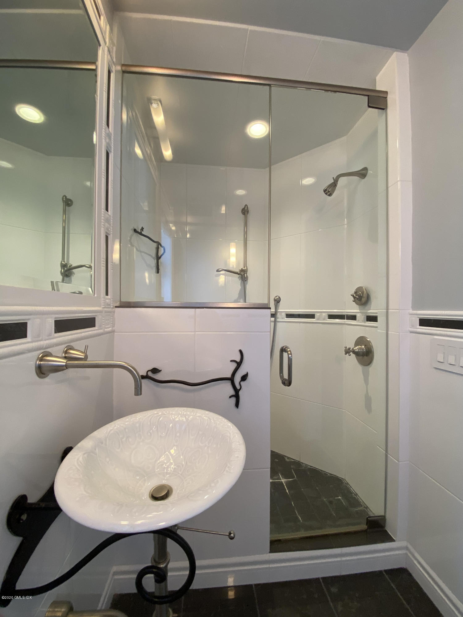 57 Shore Road Old Greenwich, CT 06870 - Photo 25 of 30 a bathroom with a sink and mirror