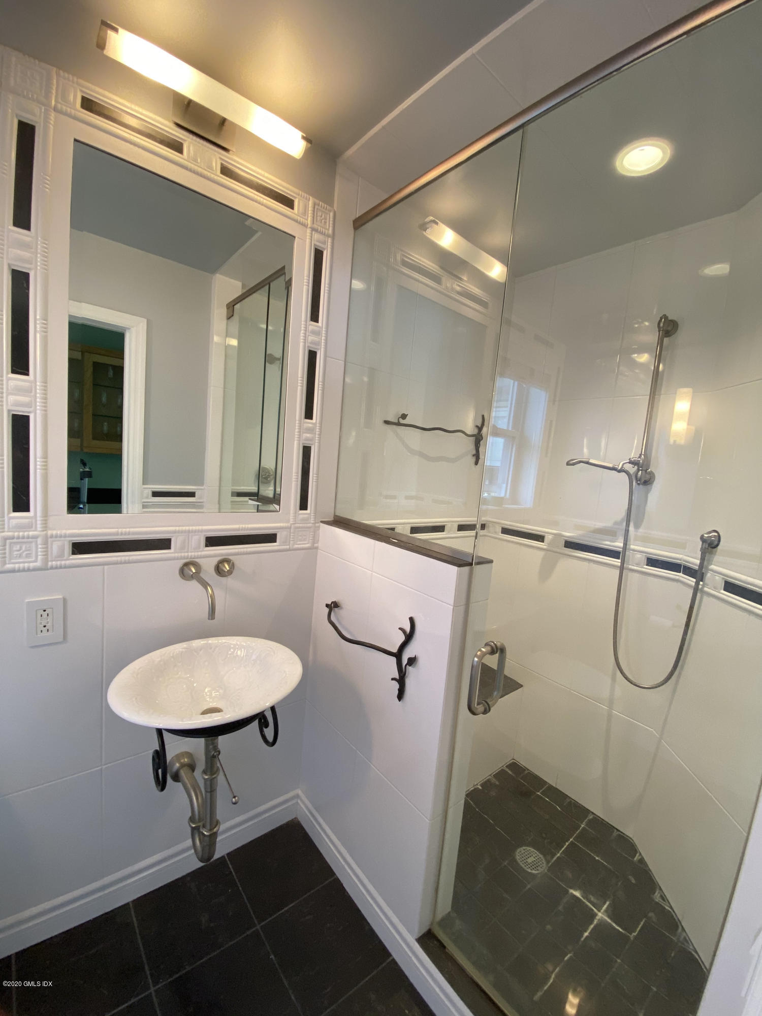 57 Shore Road Old Greenwich, CT 06870 - Photo 26 of 30 a bathroom with a sink a toilet a mirror and shower