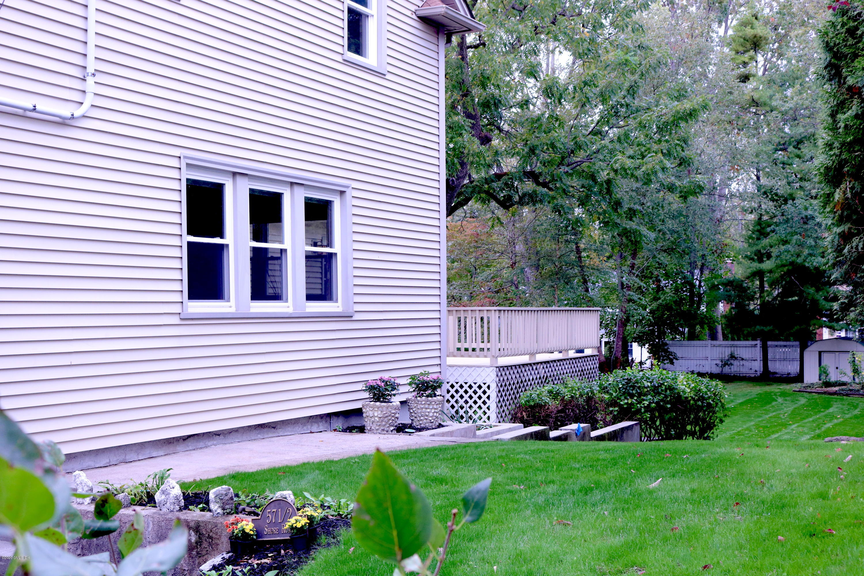 57 Shore Road Old Greenwich, CT 06870 - Photo 3 of 30 a front view of a house with a yard