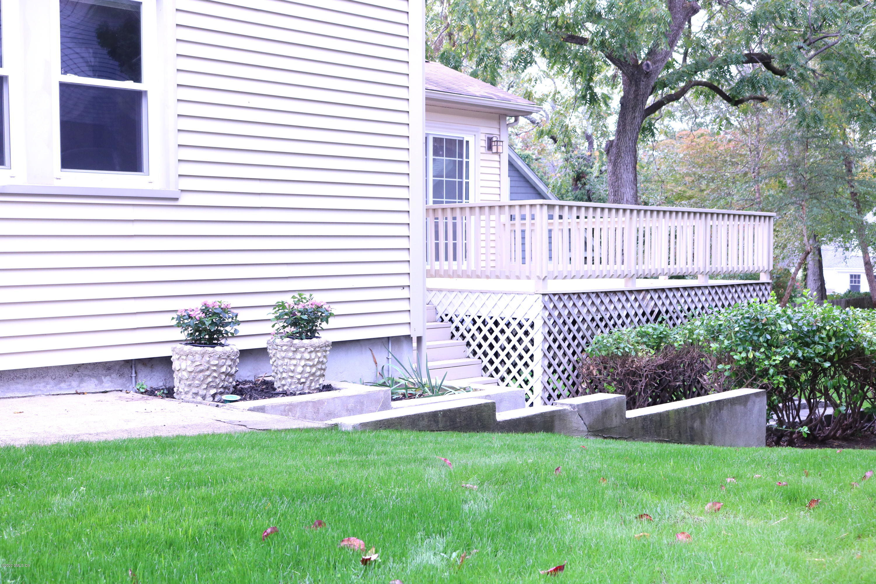57 Shore Road Old Greenwich, CT 06870 - Photo 4 of 30 a front view of a house with a garden
