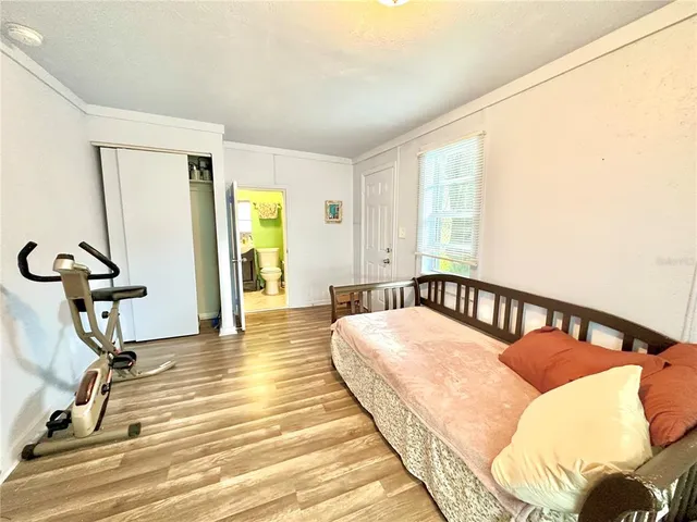 a view of a hallway with wooden floor and windows