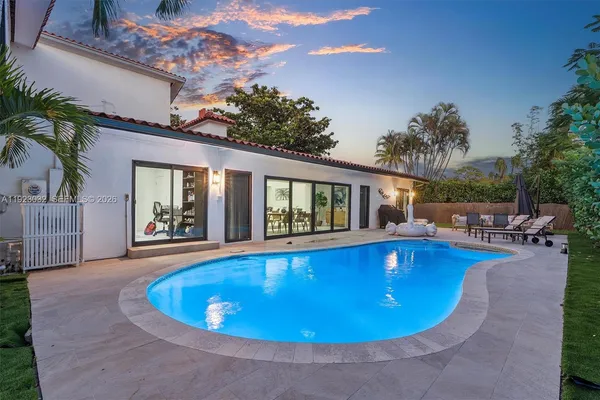a view of swimming pool with outdoor seating and plants