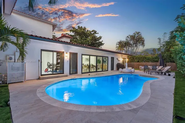 a view of swimming pool with outdoor seating and plants