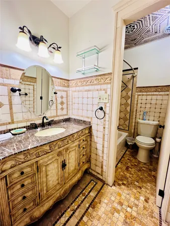 a spacious bathroom with a granite countertop sink and a mirror