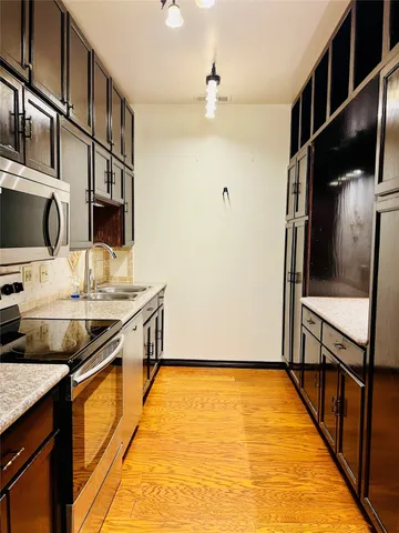 a kitchen with stainless steel appliances granite countertop a stove and a microwave
