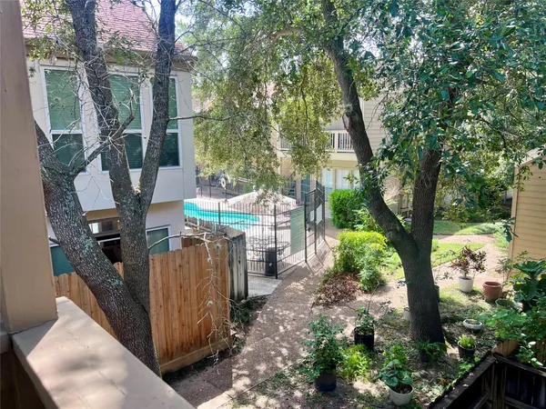 a view of a house with a tree in the background