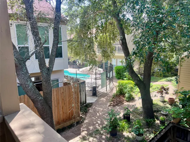 a view of a house with a tree in the background