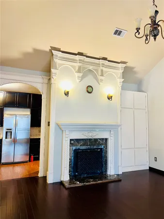 a living room with a fireplace and a wooden floor