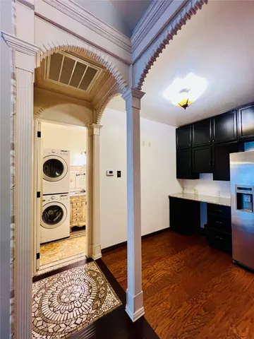 a view of a walk in closet and wooden floor