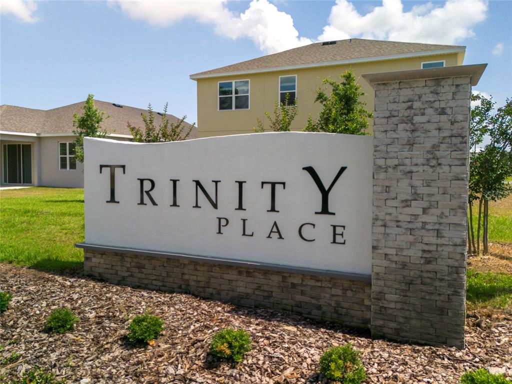 6080 Vision Road St. Cloud, FL 34771 - Photo 2 of 6 a sign board with a house in the background