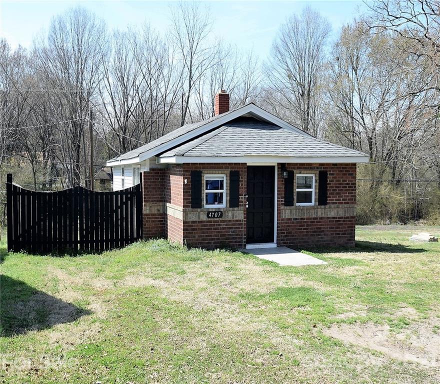 4707 Boyd Griffin Road Monroe, NC 28110 - Photo 1 of 12 a front view of a house with yard and trees