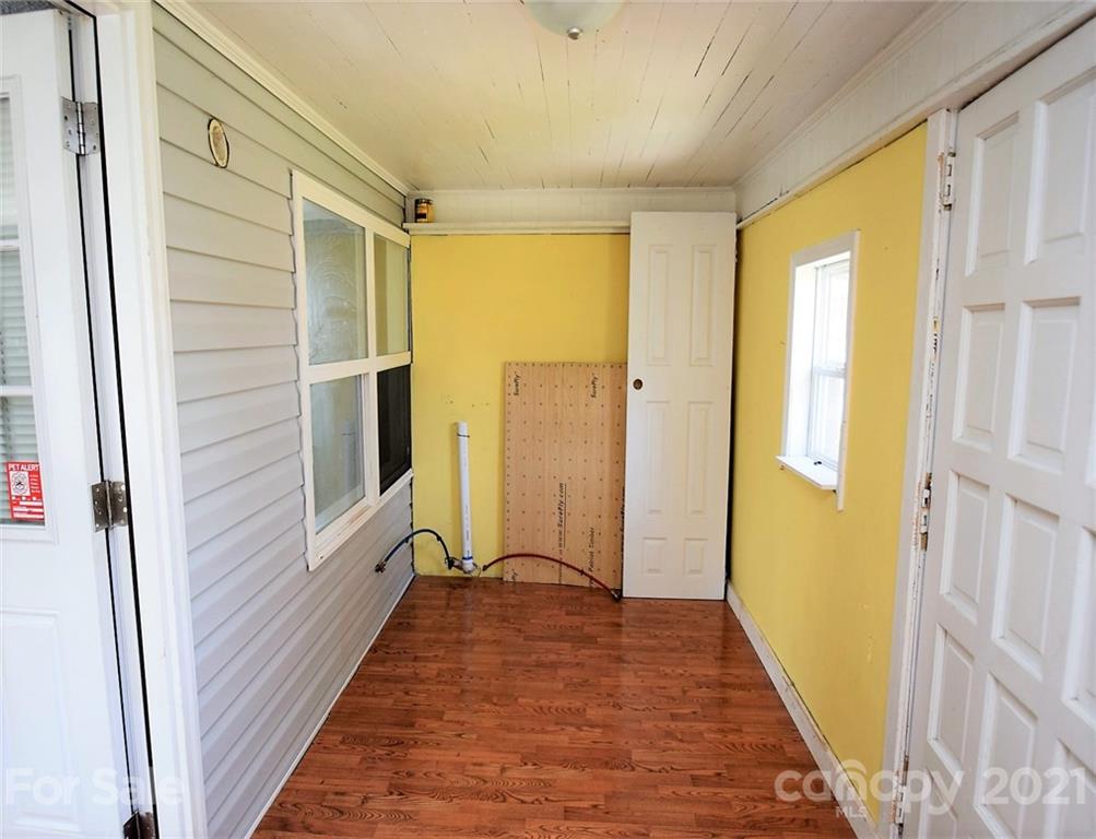 4707 Boyd Griffin Road Monroe, NC 28110 - Photo 11 of 12 a view of a hallway with wooden floor and staircase