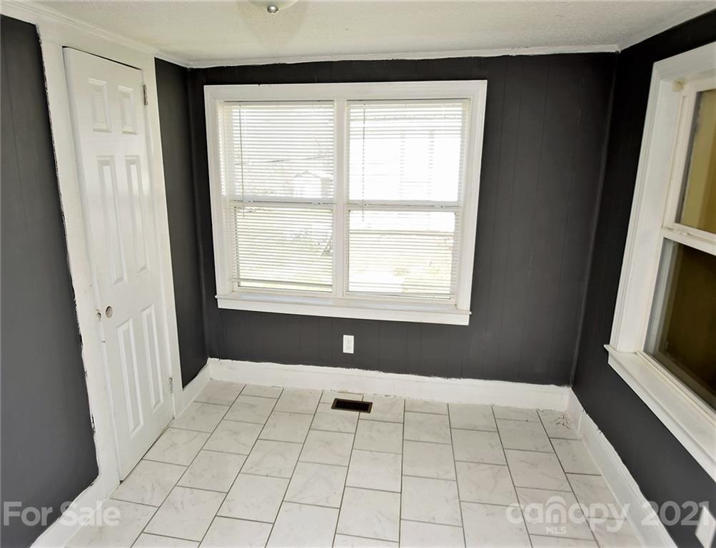 4707 Boyd Griffin Road Monroe, NC 28110 - Photo 5 of 12 a view of an empty room with window and chandelier