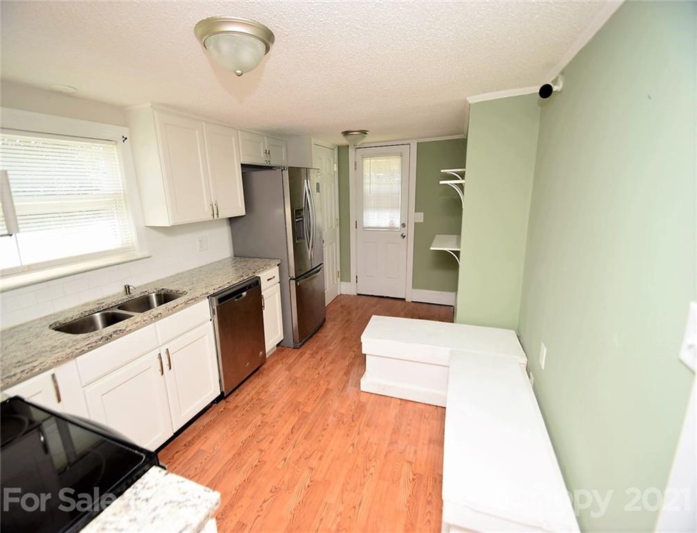 4707 Boyd Griffin Road Monroe, NC 28110 - Photo 6 of 12 a room with a bed and a stove top oven