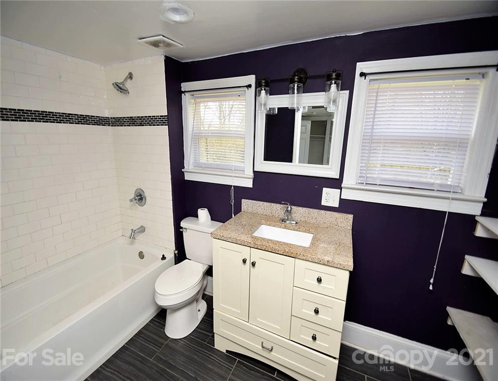4707 Boyd Griffin Road Monroe, NC 28110 - Photo 9 of 12 a bathroom with a sink a toilet and a bathtub