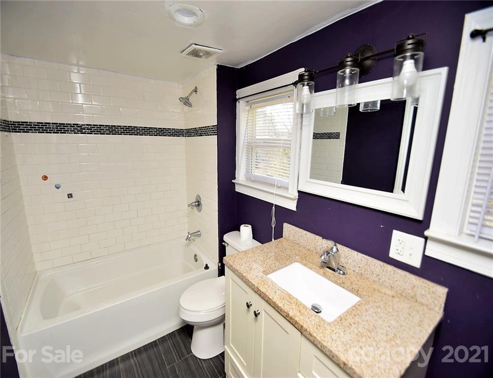 4707 Boyd Griffin Road Monroe, NC 28110 - Photo 10 of 12 a bathroom with a granite countertop sink toilet and shower