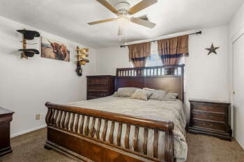 1666 Palma Road Bullhead City, AZ 86442 - Photo 12 of 22 a bedroom with a bed and a chandelier
