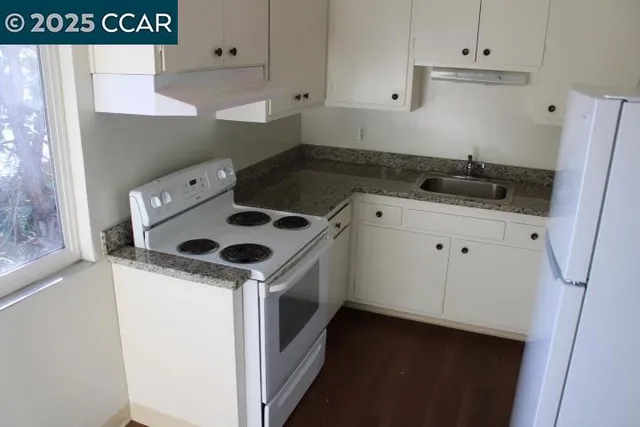 a kitchen with a sink a stove and refrigerator