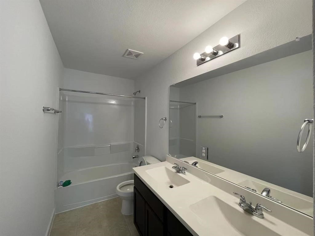 815 Summer Village Way Rosenberg, TX 77469 - Photo 18 of 21 a bathroom with a sink a toilet a shower and a mirror