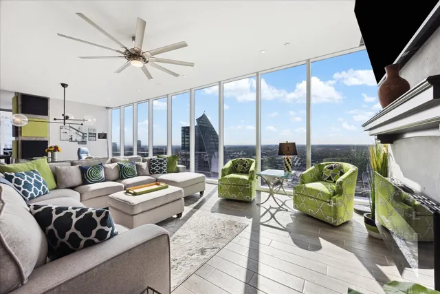 a living room with patio furniture and a large window