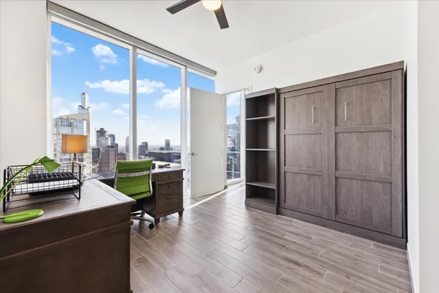 a living room with furniture and a floor to ceiling window