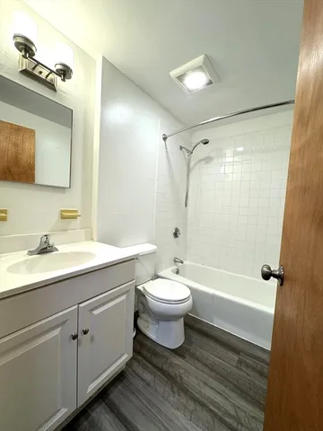 a bathroom with a double vanity sink toilet mirror and shower