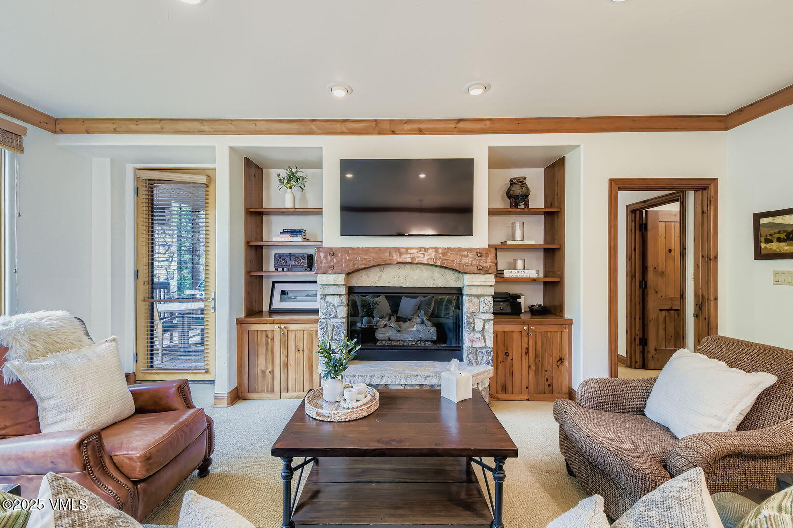 a living room with fireplace furniture and a flat screen tv