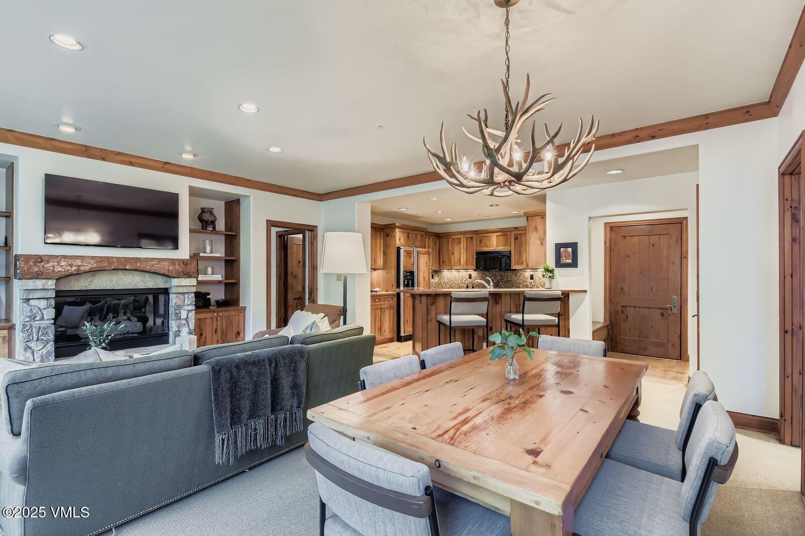 51 Offerson Road, Unit 202 Beaver Creek, CO 81620 - Photo 4 of 19 a view of a dining room with furniture window and wooden floor