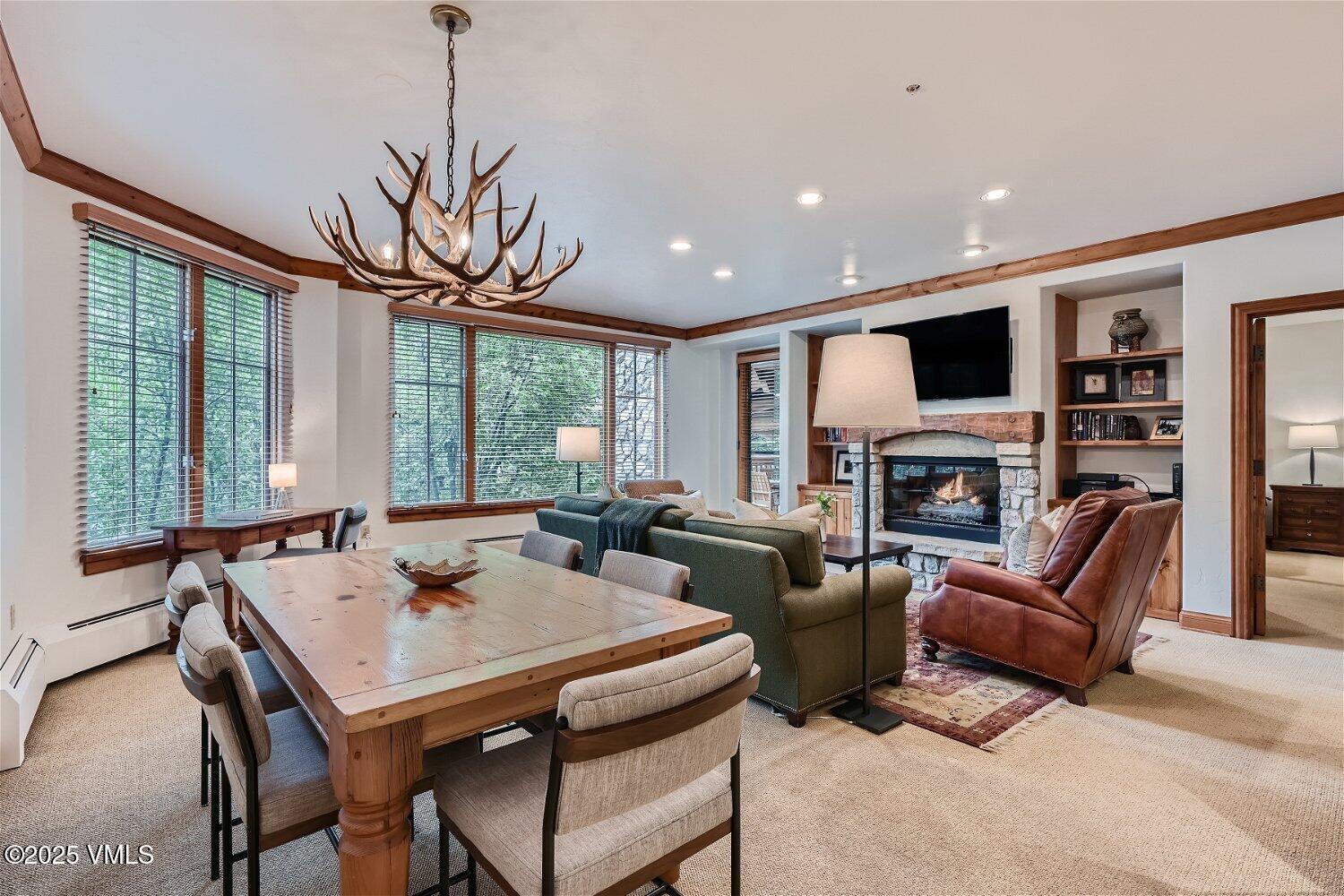 51 Offerson Road, Unit 202 Beaver Creek, CO 81620 - Photo 5 of 19 a living room with furniture a fireplace and a flat screen tv