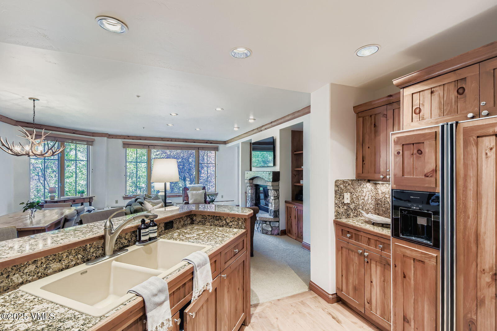 51 Offerson Road, Unit 202 Beaver Creek, CO 81620 - Photo 7 of 19 a large kitchen with kitchen island granite countertop a large window and stainless steel appliances
