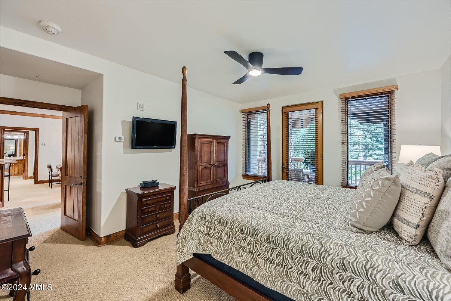 51 Offerson Road, Unit 202 Beaver Creek, CO 81620 - Photo 8 of 19 a bedroom with a bed flat screen tv and a large window