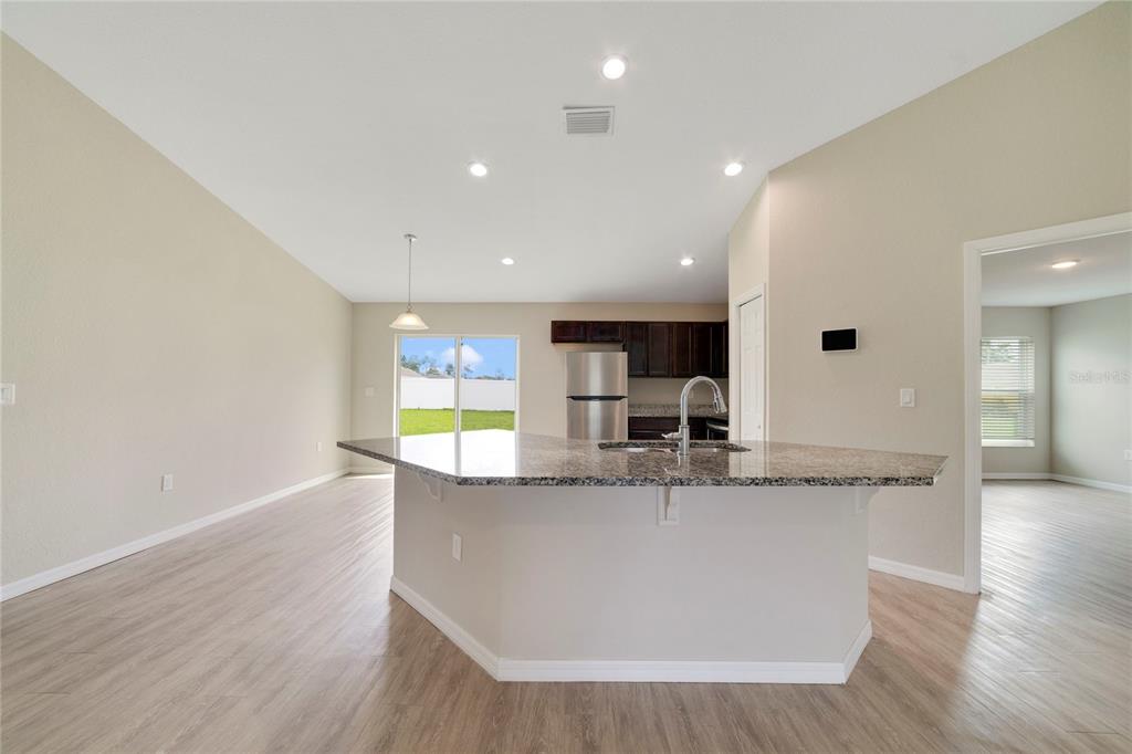 16271 Southwest 27th Terrace Road Ocala, FL 34473 - Photo 4 of 21 a kitchen with stainless steel appliances granite countertop a sink and a wooden floors