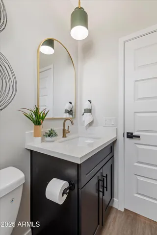 a bathroom with a sink a toilet and a mirror