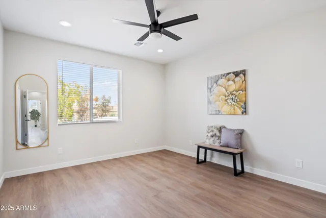 a view of workspace with wooden floor ceiling fan and windows