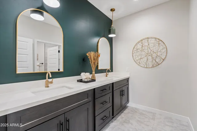 a bathroom with a double vanity sink and a mirror