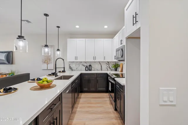 a kitchen with kitchen island granite countertop a sink a counter space and cabinets