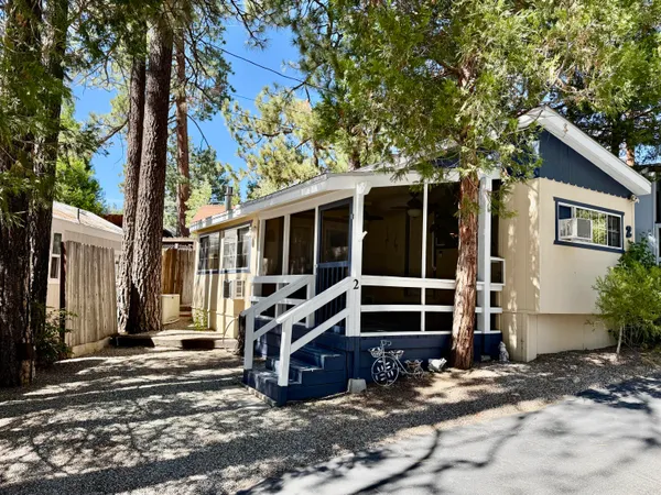 a view of a house with a large window and wooden fence