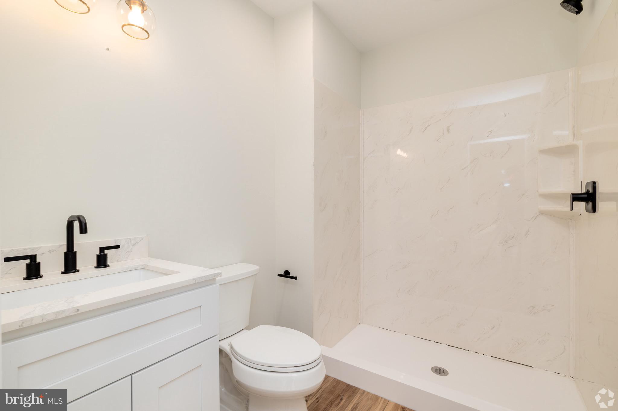 112 Washington Avenue, Unit 4 Downingtown, PA 19335 - Photo 4 of 7 a bathroom with a sink toilet and shower