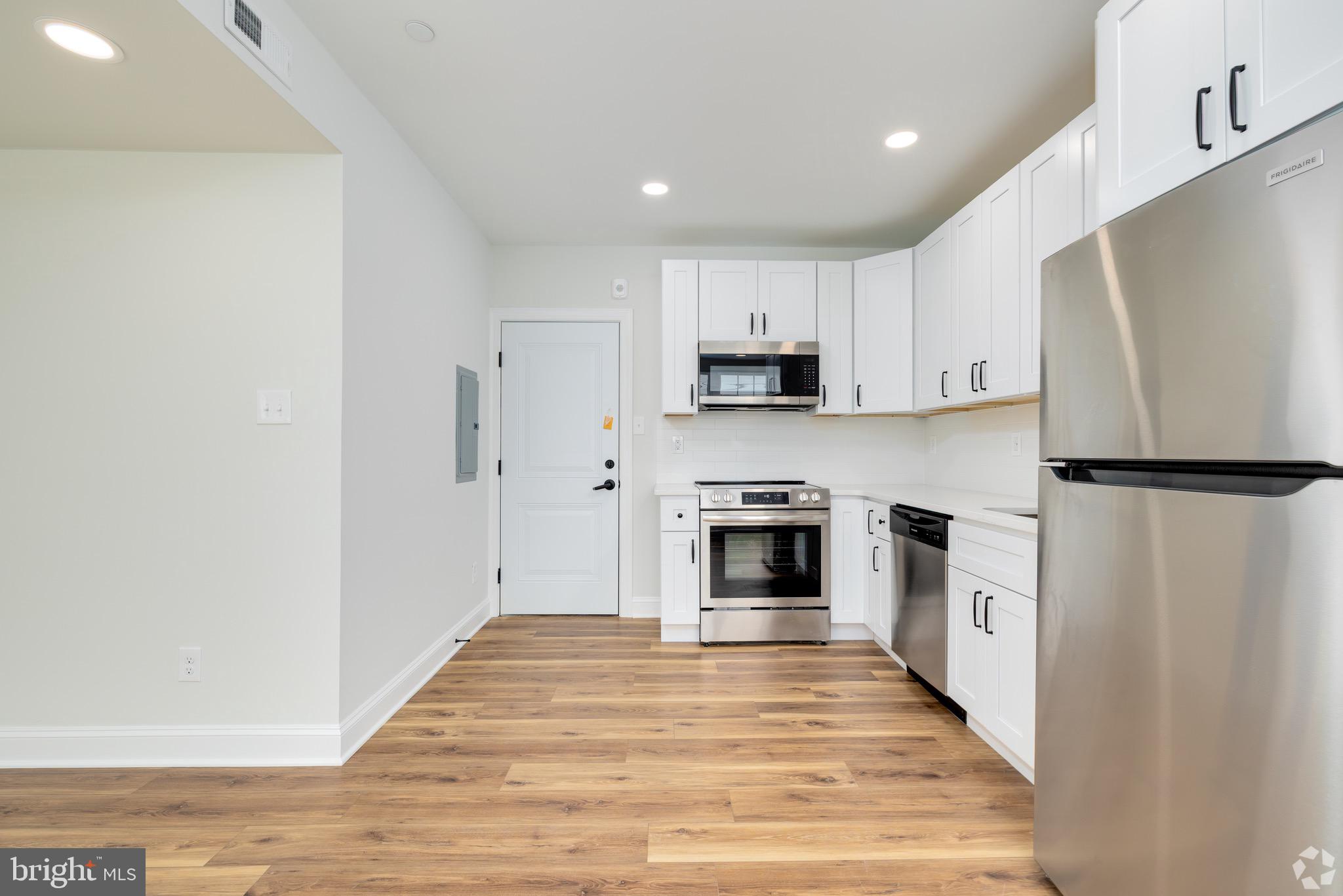 112 Washington Avenue, Unit 4 Downingtown, PA 19335 - Photo 7 of 7 a kitchen with white cabinets and stainless steel appliances