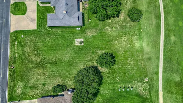 an aerial view of a house with pool yard and outdoor seating