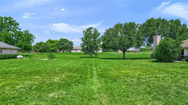 a view of grassy field with benches